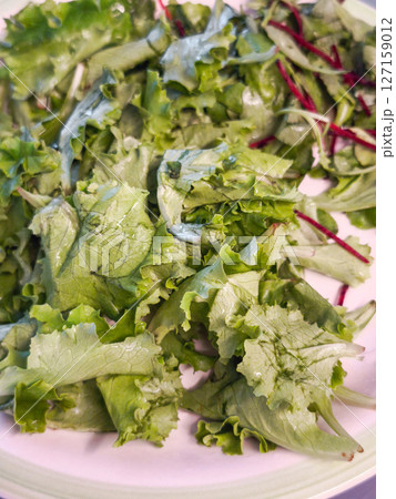 Close up of crisp green vegetables fresh, nutritious on white ceramic plate 127159012