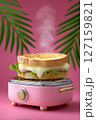Cuban medianoche sandwich sizzling on pink press with cheese ribbons escaping. Bright tropical setting with palm leaves in background. Concept of food service, cafes, restaurants 127159821