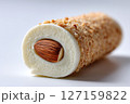 Close-up view of almond-filled sweet treat with a crunchy, golden layer. Bright and inviting presentation suggests dessert indulgence. Concept of confectionery, snack food, food styling 127159822