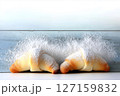 Almond croissants topped with sugar dusting display minimalist style against white backdrop. Fresh bakery setting evokes warmth and indulgence. Concept of pastry shops, cafes, gourmet food 127159832