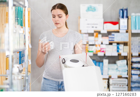 Pregnant girl buys breast pump in modern pharmacy Pregnant girl buys breast pump in modern pharmacy 127160283
