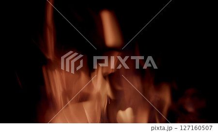Captivating, mesmerizing flames gracefully dancing vividly against a dark, shadowy background Captivating, mesmerizing flames gracefully dancing vividly against a dark, shadowy background 127160507