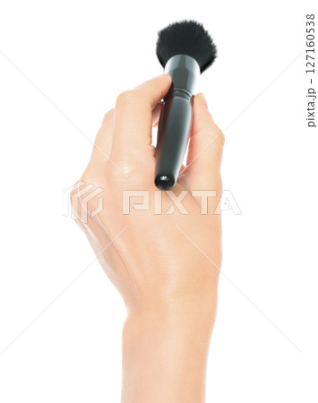 Woman hand holds black cosmetics brush, isolated on transparent background, cosmetics and visage concept 127160538