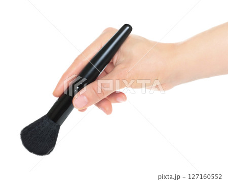Woman hand holds black cosmetics brush, isolated on transparent background, cosmetics and visage concept 127160552