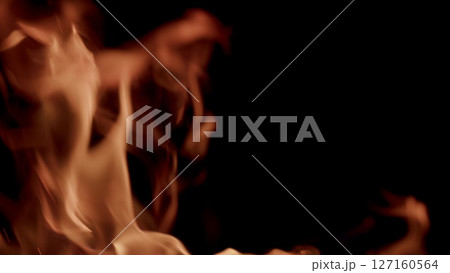 Dynamic Flames with Vibrant Orange and Deep Red Hues Set Against a Black Background Dynamic Flames with Vibrant Orange and Deep Red Hues Set Against a Black Background 127160564