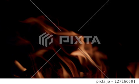 Captivating Flames are Constantly Dancing Passionately in the Dark, Creating a Mesmerizing Display Captivating Flames are Constantly Dancing Passionately in the Dark, Creating a Mesmerizing Display 127160591