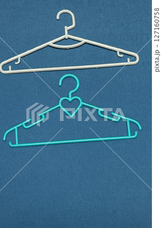 Two Plastic Clothes Hangers on Minimal Background 127160758