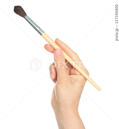 Woman hand holds paint brush, isolated on transparent background, painting and design concept 127160800