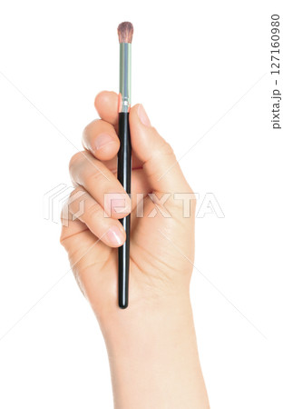 Woman hand holds black cosmetics brush, isolated on transparent background, cosmetics and visage concept Woman hand holds black cosmetics brush, isolated on transparent background, cosmetics and visage concept 127160980