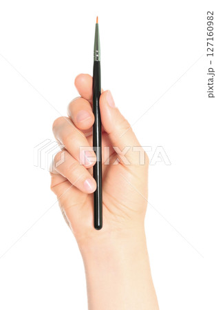 Woman hand holds black cosmetics brush, isolated on transparent background, cosmetics and visage concept 127160982