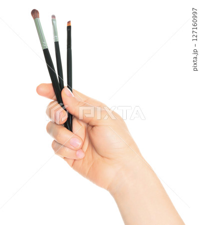 Woman hand holds Cosmetics Brushes, isolated on transparent background, cosmetics and visage concept 127160997
