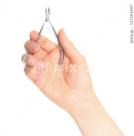 Woman hand holds cosmetic cuticle nippers, isolated on transparent background, cosmetics and visage concept Woman hand holds cosmetic cuticle nippers, isolated on transparent background, cosmetics and visage concept 127161007