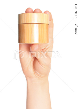 Woman hand holds a wooden cosmetic cream jar, on transparent background close-up, template for cosmetics ads Woman hand holds a wooden cosmetic cream jar, on transparent background close-up, template for cosmetics ads 127161051
