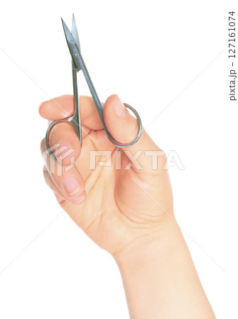 Woman hand holds cosmetic scissors, isolated on transparent background, cosmetic tools concept Woman hand holds cosmetic scissors, isolated on transparent background, cosmetic tools concept 127161074