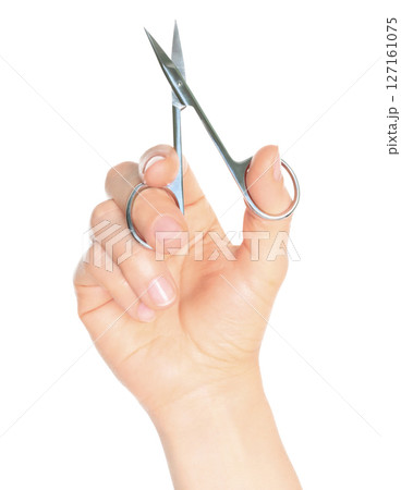 Woman hand holds cosmetic scissors, isolated on transparent background, cosmetic tools concept 127161075