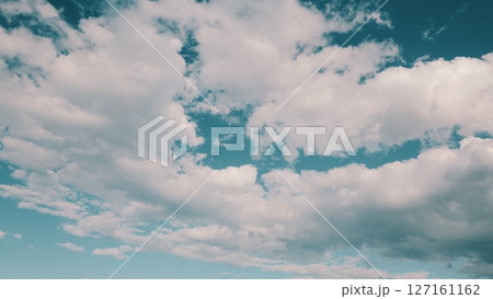 A Beautiful Cloudy Sky with a Bright Blue Background creates a charming atmosphere A Beautiful Cloudy Sky with a Bright Blue Background creates a charming atmosphere 127161162