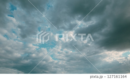 Dramatic Cloudy Skies with Beautiful Light Blue Patches, a Truly Captivating Sight 127161164