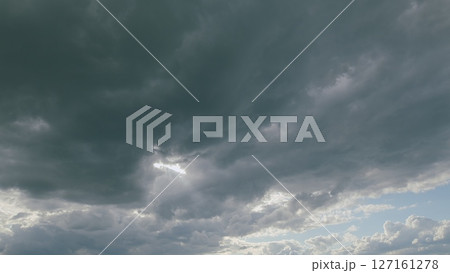 An Incredible and Dramatic Cloud Formation with Intermittent Rays of Sunlight Peeking Through 127161278