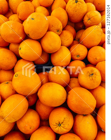 lots of orange fruits for food as background 127162014