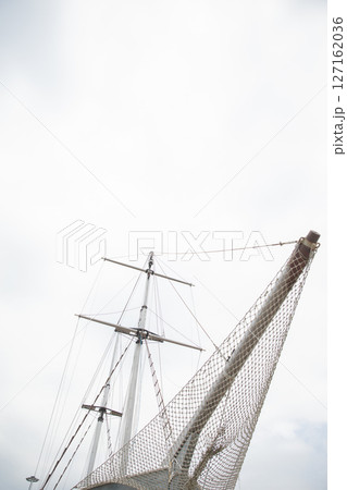 masts of a wooden sailing ship in the roadstead masts of a wooden sailing ship in the roadstead 127162036
