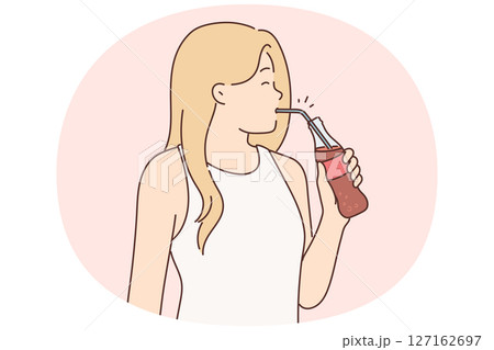 Young woman drinking soda from bottle using straw enjoying invigorating chilled drink Young woman drinking soda from bottle using straw enjoying invigorating chilled drink 127162697