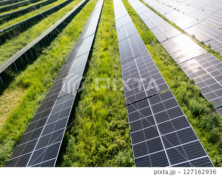 Aerial view of solar power station on a green field. Sustainable development. Aerial view of solar power station on a green field. Sustainable development. 127162936