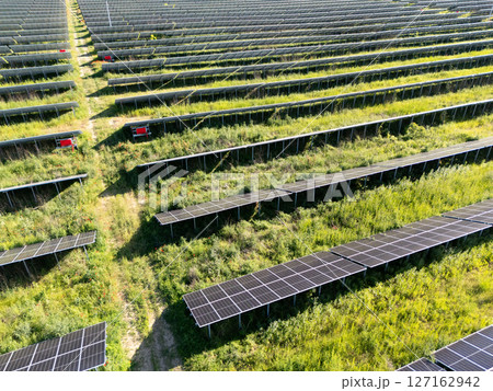 Aerial view of solar power station on a green field. Sustainable development. 127162942