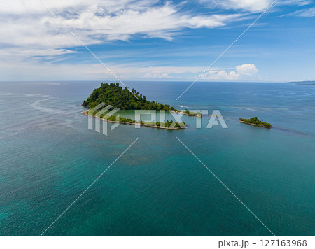Air survey of Tropical island with a beach in the open ocean. Cabugao Island. Mindanao, Philippines. Air survey of Tropical island with a beach in the open ocean. Cabugao Island. Mindanao, Philippines. 127163968