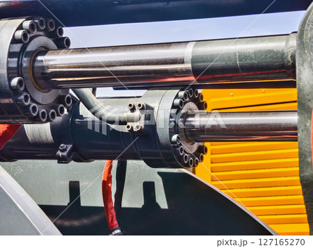 Hydraulic machinery components in a construction site during bright daylight 127165270