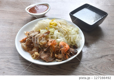Korean fried slice pork with cabbage and glass noodles on plate dipping spicy sauce couple soup Korean fried slice pork with cabbage and glass noodles on plate dipping spicy sauce couple soup 127166492