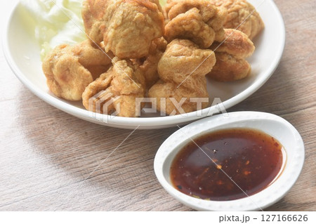deep fried crispy fish ball dressing sweet chili tamarind sauce and slice cabbage on plate deep fried crispy fish ball dressing sweet chili tamarind sauce and slice cabbage on plate 127166626