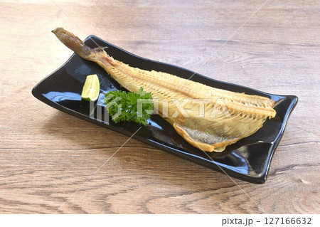 grilled salty shima hokke fish or Akta mackerel with lemon and parsley on plate  127166632