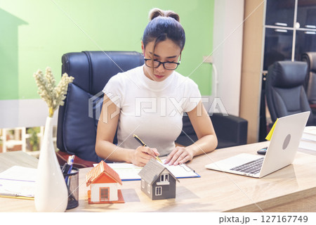 Businesswoman selling house real estate agent at office desk. Women working home insurance mortgage sale apartment. Asian women dealership real estate rental home. Businessperson agency sign contract 127167749