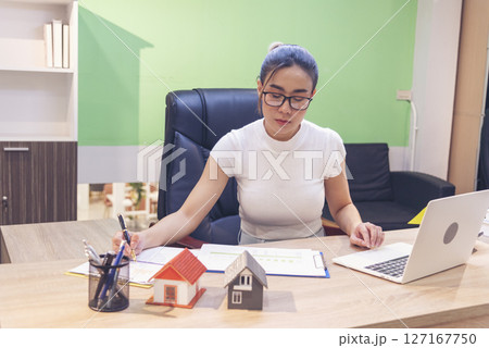 Businesswoman selling house real estate agent at office desk. Women working home insurance mortgage sale apartment. Asian women dealership real estate rental home. Businessperson agency sign contract 127167750