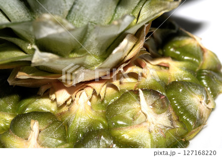 Close up of pieapple fruit skin on white background 127168220
