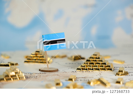 Botswana national flag alongside many scattered gold bars on a world map, symbolizing vast mineral resources and global economic investment opportunities 127168733