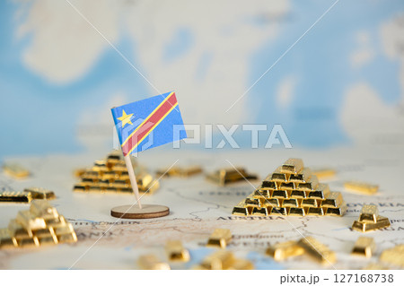 Democratic Republic of Congo flag on a global map, surrounded by many glistening gold bars, signifying national wealth, mineral resources, and economic power 127168738