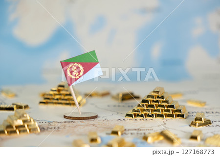 Eritrean flag on global world map featuring gold bars, symbolizing national economic wealth, valuable mineral resources, and international financial investment, offering copy space 127168773