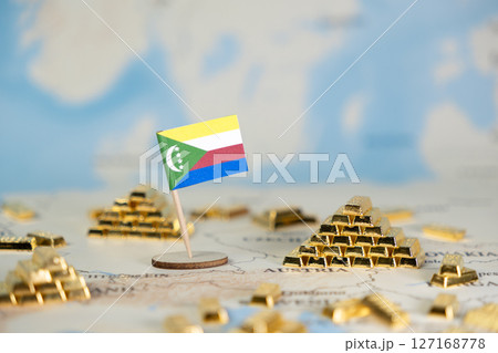 Vibrant Comoros flag stands on a world map surrounded by shiny gold bar stacks, representing national economic wealth, global finance, and investment, offering ample copy space Vibrant Comoros flag stands on a world map surrounded by shiny gold bar stacks, representing national economic wealth, global finance, and investment, offering ample copy space 127168778