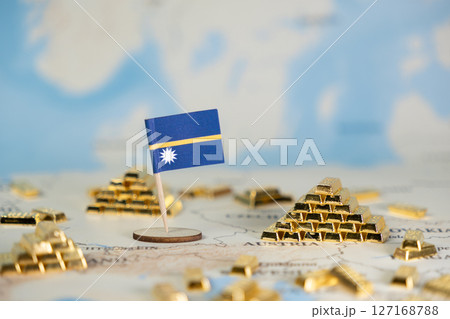 Nauru flag on world map with gold bars, symbolizing national wealth, economic growth, global investment, and finance, with clear copy space 127168788