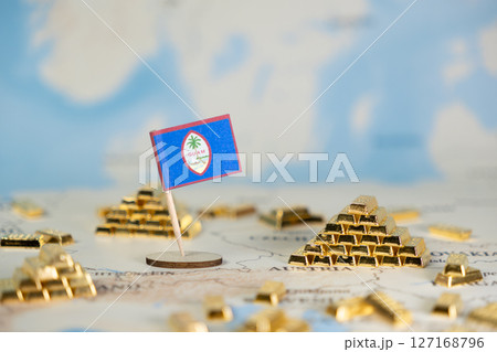 Guam national flag on a map with numerous shining gold bars, symbolizing the island's economic development, wealth, and global trade relations, featuring copy space Guam national flag on a map with numerous shining gold bars, symbolizing the island's economic development, wealth, and global trade relations, featuring copy space 127168796