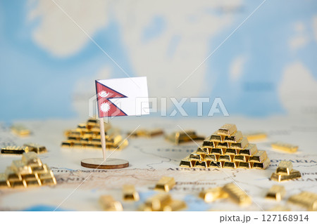 Nepal's flag on a world map with golden ingots, representing national financial wealth, global economic strategy, and international investment 127168914