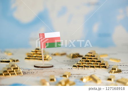 Oman flag with miniature gold bars on a world map, symbolizing national economic prosperity, global wealth, and potential investment, offering clear copy space Oman flag with miniature gold bars on a world map, symbolizing national economic prosperity, global wealth, and potential investment, offering clear copy space 127168918