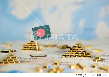 Bangladesh flag and miniature gold bar stacks on a world map symbolize global economic prosperity, national wealth, international trade, and investment strategy 127168924