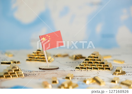 Chinese flag stands prominently on world map, surrounded by gleaming gold bars, representing global financial influence, wealth accumulation, and strategic investment, offering ample copy space 127168926