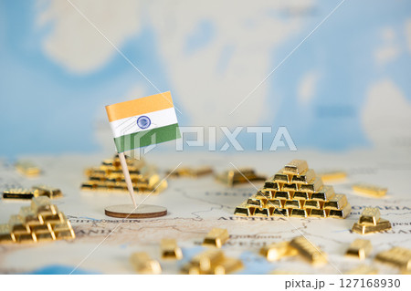 Indian flag on world map with gold bars, symbolizing national wealth, economic prosperity, and global investment opportunities, providing ample copy space 127168930