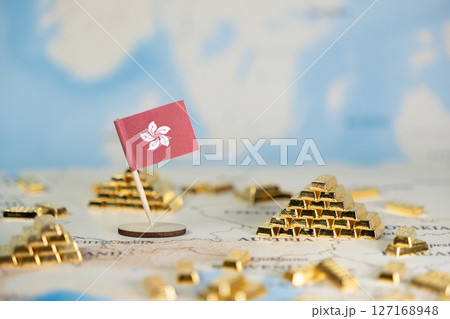 Hong Kong flag stands on a world map amidst gold bars, symbolizing global financial wealth, economic growth, and international investment opportunities 127168948