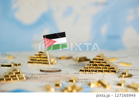Palestine flag on world map with gold bar stacks, symbolizing national economy, global financial power, and strategic resource management with copy space 127168949