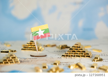 Myanmar flag with gold bars on a world map representing national economy, wealth, investment, global trade, and economic growth potential with copy space for text 127168951