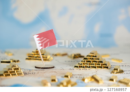 Bahrain's national flag on a world map with gold bar stacks, symbolizing global trade and national wealth, featuring ample copy space for economic data Bahrain's national flag on a world map with gold bar stacks, symbolizing global trade and national wealth, featuring ample copy space for economic data 127168957